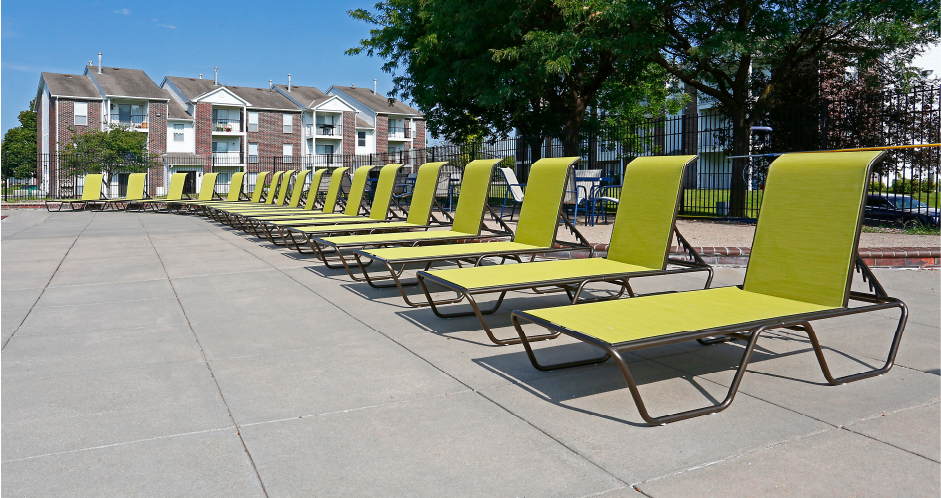 Huge spacious sundeck, poolside lounge chairs, beautiful landscaping, and scenic views at The Vanderbilt Apartments in Omaha, Nebraska