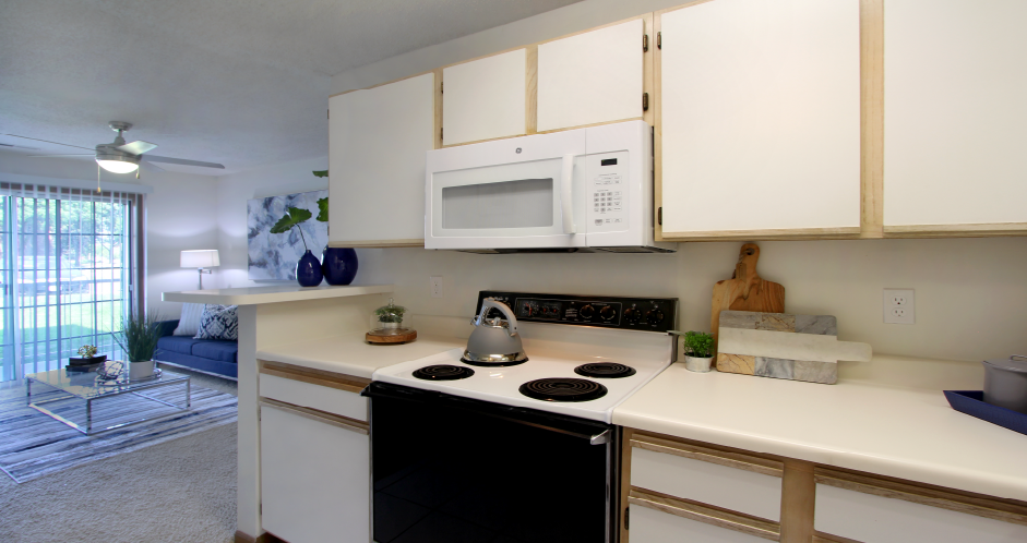 Spacious kitchen with extra cabinet space, extra counter space, tiled floors, bright white kitchen, at Tanglewood Apartments in Lincoln, Nebraska