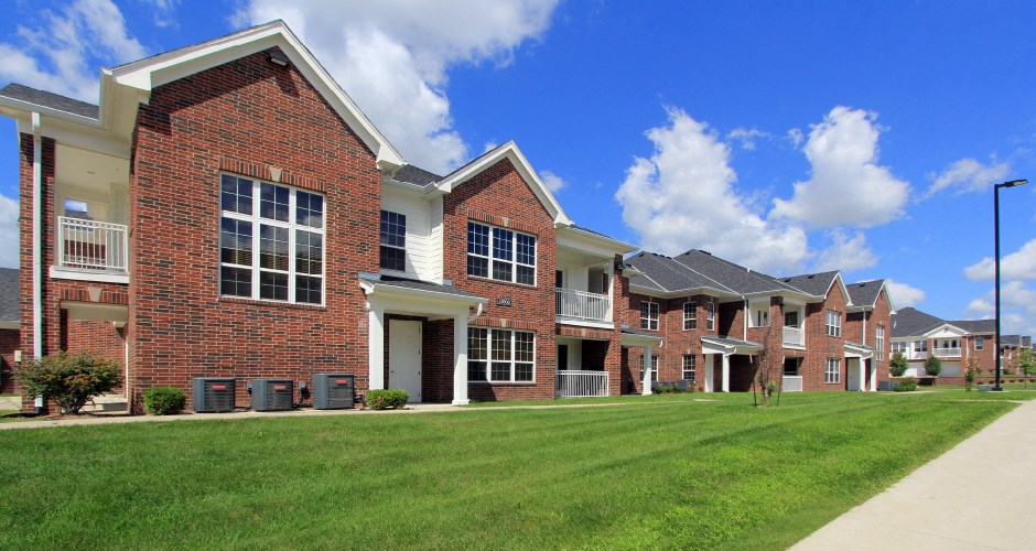 Luxury townhomes with attached garages and red brick exteriors at Bellemeade Apartments in west Des Moines
