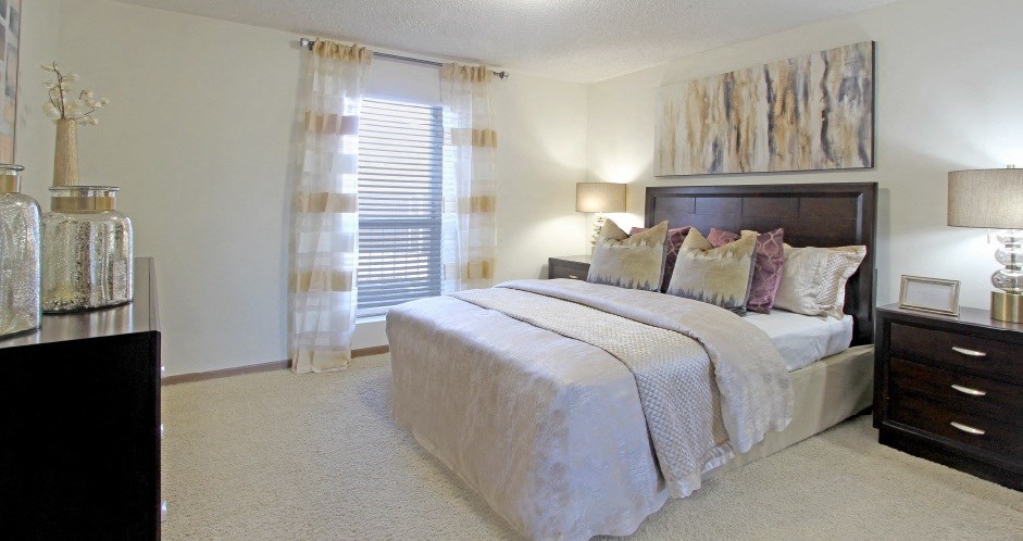 Spacious master bedroom with attached walk-in closet and master bathroom at LionsGate Apartments in Lincoln, Nebraska