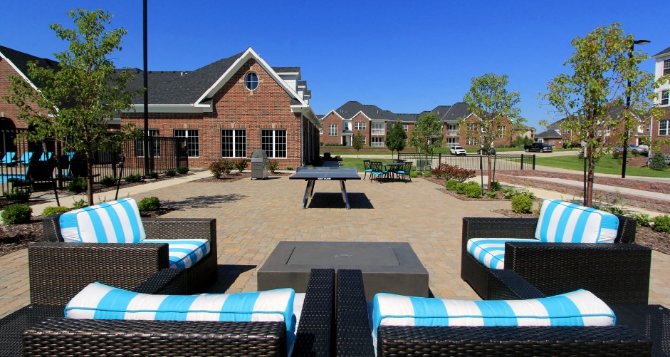 Luxury apartments with swimming pool, poolside lounges, grilling station, ping-pong table and brick exteriors at Bellemeade Apartments in west Des Moines