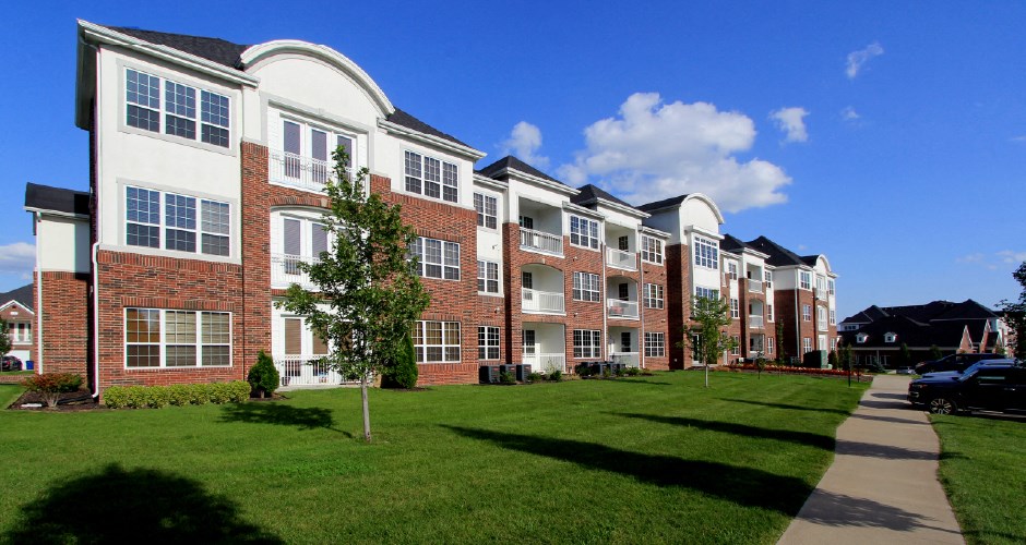 Luxury apartments in a gated community with brick exteriors and underground parking garage at Bellemeade Apartments in west Des Moines