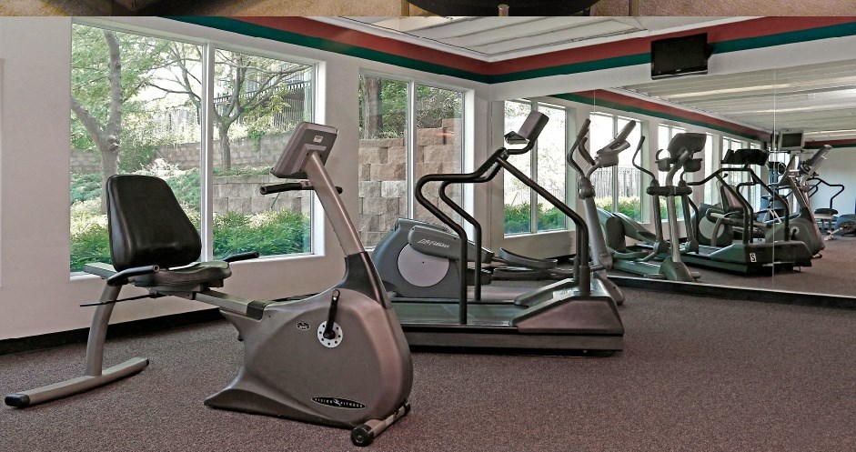 a gym with a lot of exercise equipment in it