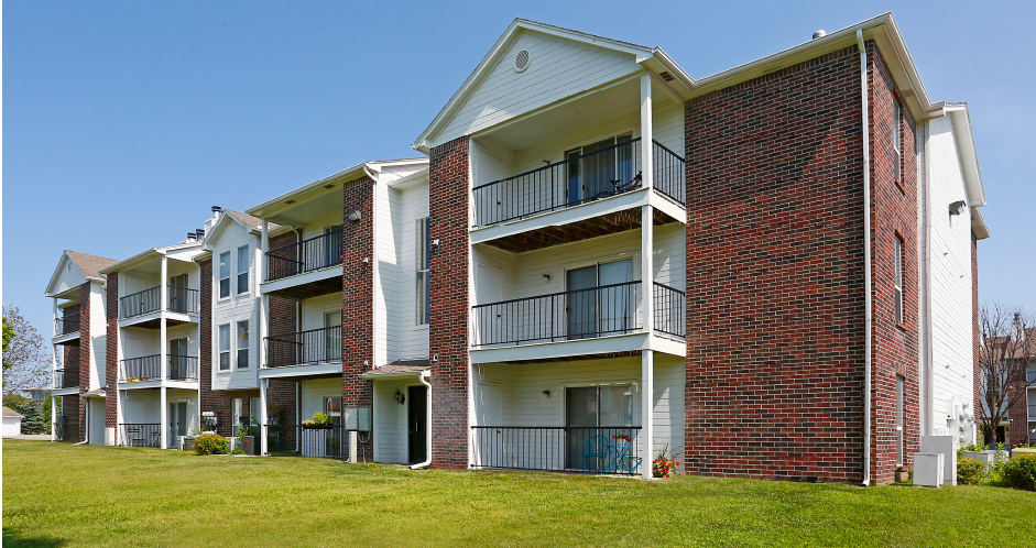 Apartments with red brick exteriors and large balconies at The Vanderbilt Apartments in Omaha, Nebraska