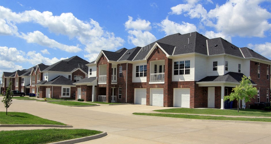 Luxury townhomes with attached garages and red brick exteriors at Bellemeade Apartments in west Des Moines