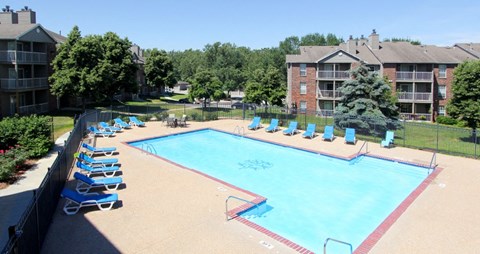 Apartments in Lincoln, Nebraska with two swimming pools, scenic views, lots of trees, poolside lounge chairs, and extra large sundeck