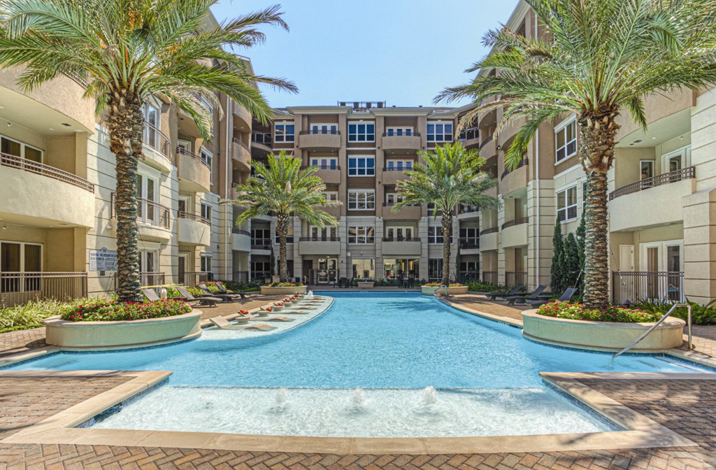 Luxury apartments with resort-style pool and palm trees, fountains, lap lane, and pool-side lounge chairs