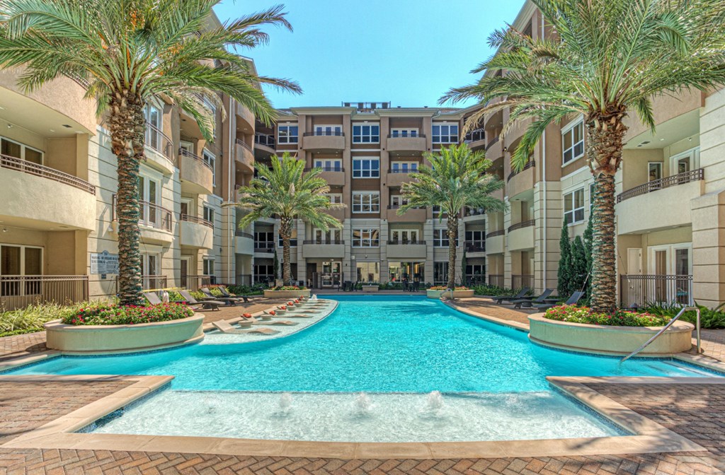 Luxury apartments with resort-style pool and palm trees, fountains, lap lane, and pool-side lounge chairs