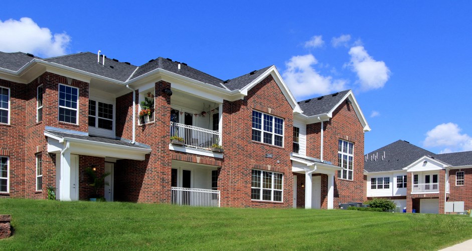 Luxury townhomes with attached garages and red brick exteriors at Bellemeade Apartments in west Des Moines