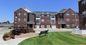 Luxury apartments with red brick exteriors, resident grilling station, and attached garages at Rockledge Oaks Apartments in Lincoln, Nebraska - Photo Gallery 29