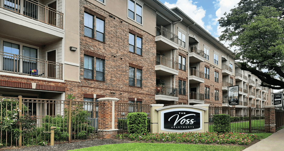 Luxury apartments with brick exteriors, two swimming pools, parking garage, and fitness center at The Voss Apartments in Houston.