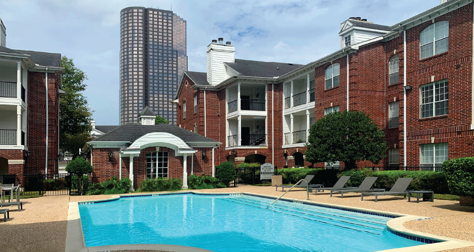 Luxury swimming pool with large sundeck at Tuscany Gate Apartments in Houston.