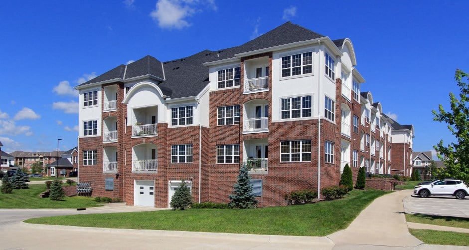 Luxury apartments in a gated community with brick exteriors and underground parking garage at Bellemeade Apartments in west Des Moines