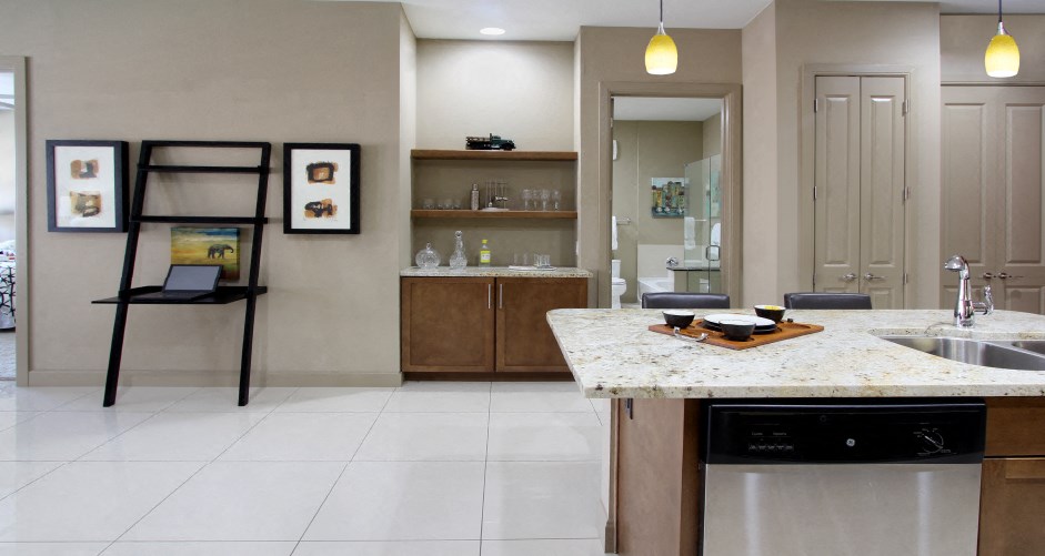 Luxury apartments with spacious open floor plan, porcelain tile floors, and built-in buffet with granite countertop at Bellemeade Apartments in west Des Moines