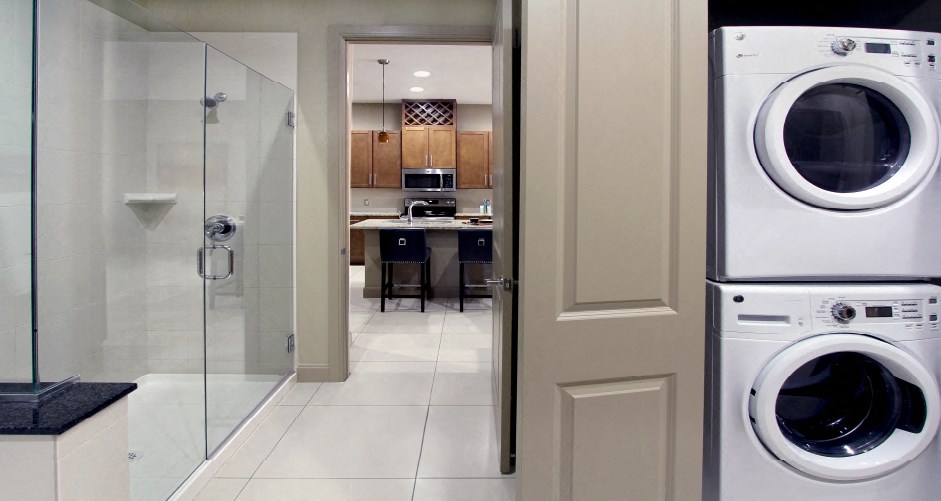 Luxury apartments with front-loading washer and dryer, glass shower, and separate oval soaking tub at Bellemeade Apartments in west Des Moines