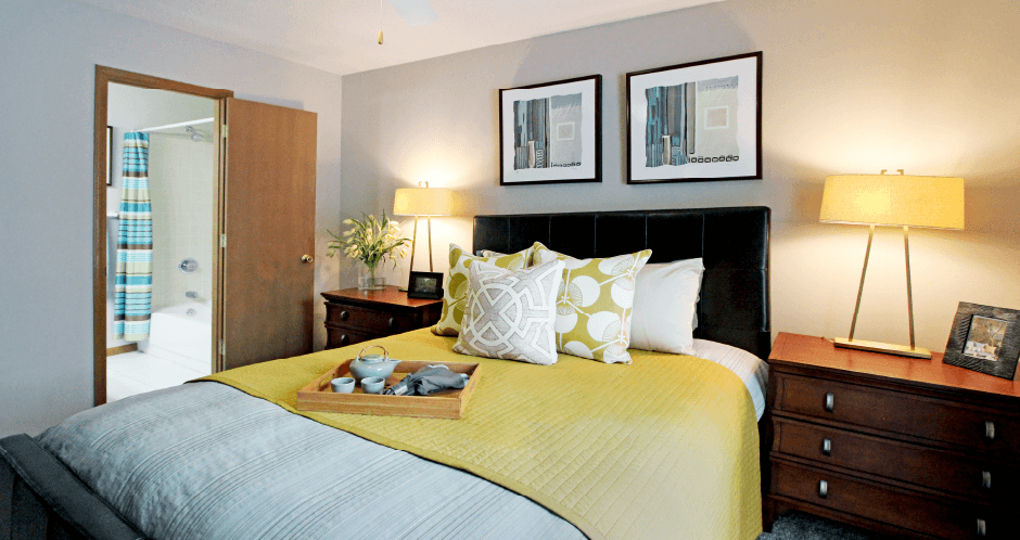 Spacious master bedroom with walk-in closet, master bathroom, and gray wall color at The Vanderbilt Apartments in Omaha, Nebraska