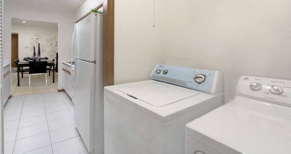 Apartments with full-size washer and dryer in unit, laundry room, bright white kitchen at LionsGate Apartments in Lincoln, Nebraska