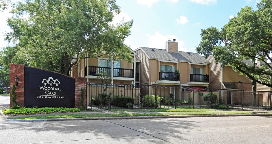 Gated apartments with convenient bayou location, scenic views, attached garages and covered parking at Woodlake Oaks Apartments in Houston