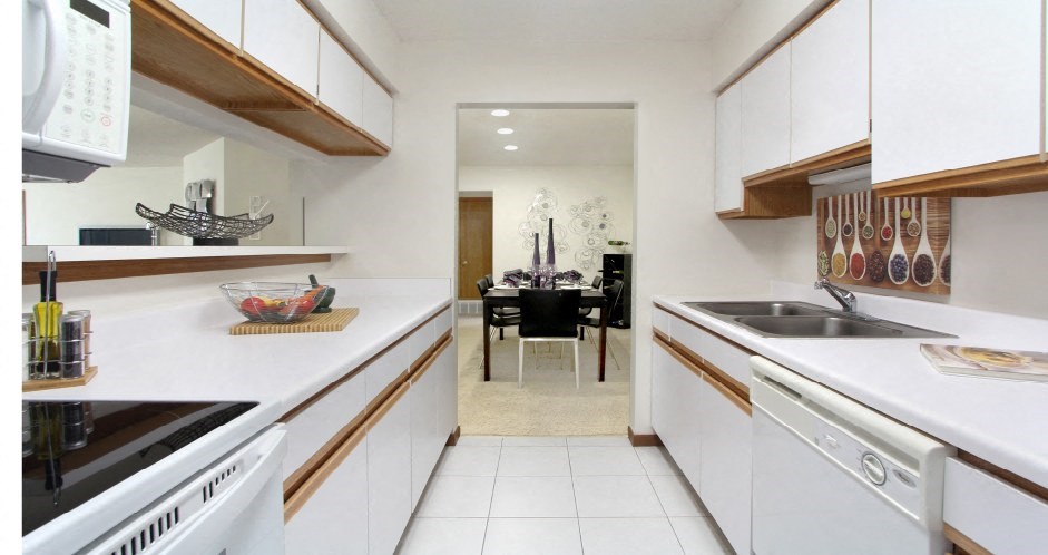 Bright white kitchen with lots of cabinet space, lots of counter space, and spacious dining room at at LionsGate Apartments in Lincoln, Nebraska