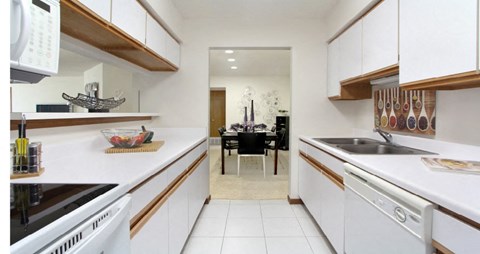 a kitchen with a sink and a stove and a dining room