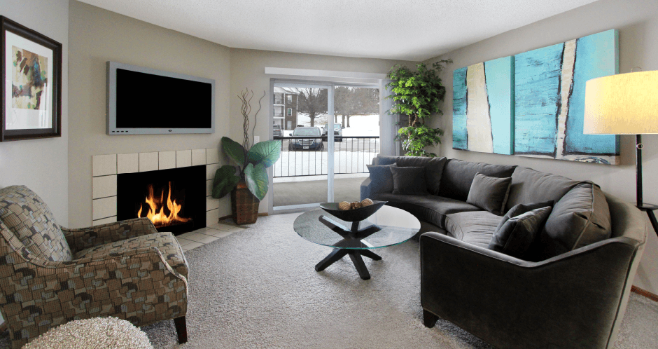 Spacious floor plan, open floor plan, spacious apartment with woodburning fireplace, spacious dining room, and gray wall color at The Vanderbilt Apartments in central Omaha, Nebraska