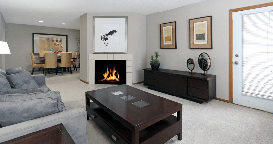 Spacious floor plan, open floor plan, spacious apartment with woodburning fireplace, spacious dining room, and gray wall color at The Vanderbilt Apartments in Omaha, Nebraska
