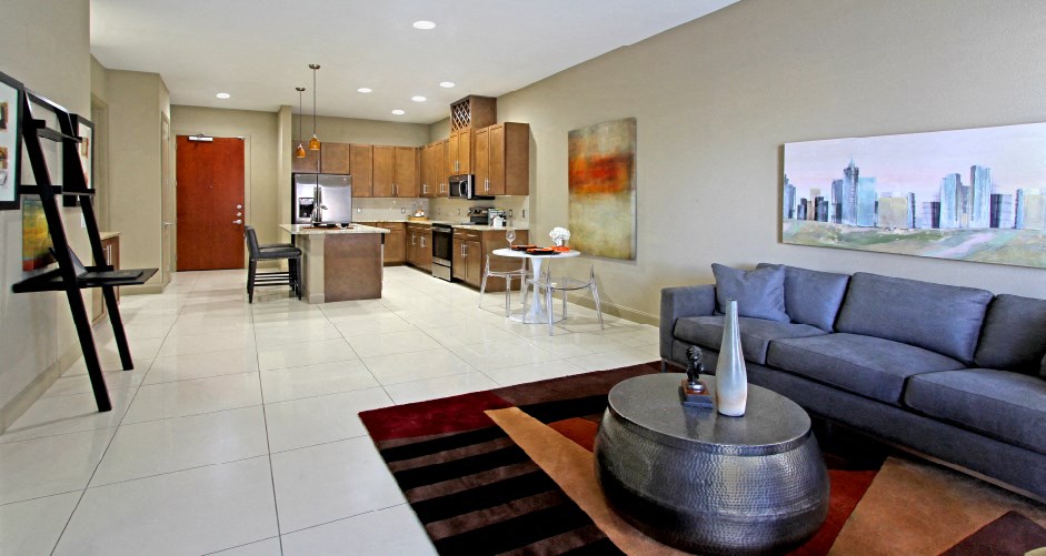 Luxury apartments with spacious open floor plan, granite countertops, stainless steel appliances, built-in wine rack, kitchen island, and porcelain tile floor at Bellemeade Apartments in west Des Moines