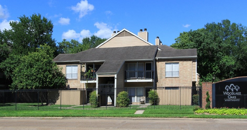 Gated apartments with convenient bayou location, scenic views, attached garages and covered parking at Woodlake Oaks Apartments in Houston