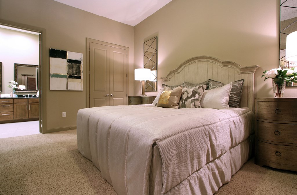 Master bedroom to accommodate a king-size bed and dresser with walk-in closet and master bathroom at Tuscany Apartments in Houston