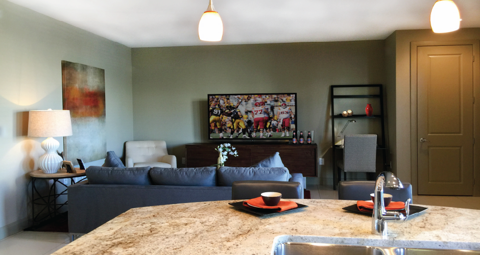 Spacious luxury apartments with colored feature wall and granite countertops at Bellemeade Apartments in west Des Moines