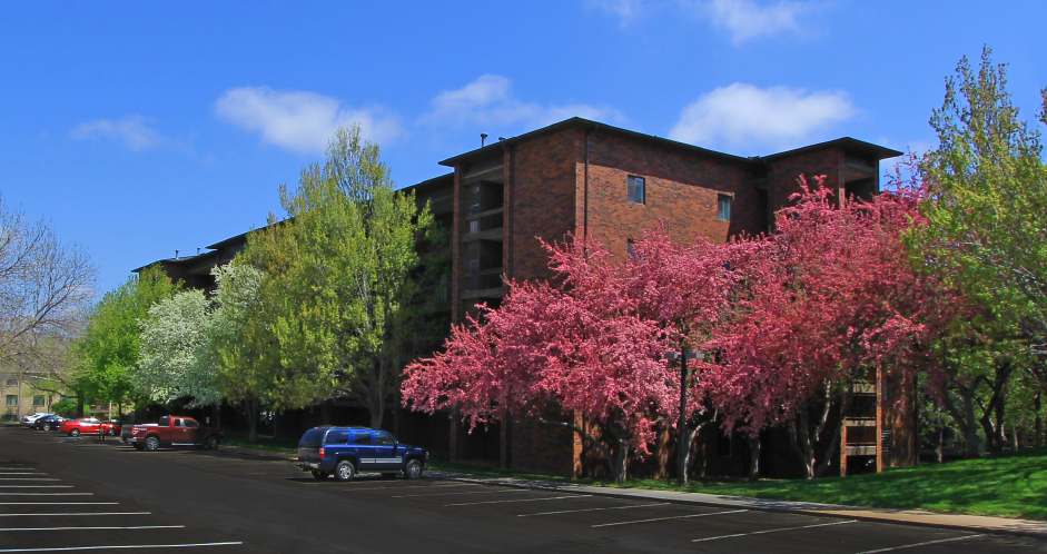 Apartments in central Omaha with brick exteriors, huge balconies, spacious balconies, scenic views, lots of trees, and beautiful landscaping at Embassy Park Apartments in Omaha, Nebraska