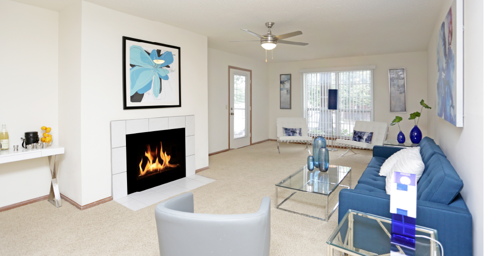 Apartments in central Lincoln Nebraska with spacious living room, spacious floor plan, huge living room, and woodburning fireplace at Tanglewood Apartments