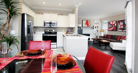 a kitchen and dining room with a table and chairs