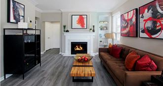Luxury apartments with wood plank floors, gas fireplaces, built-in shelves, and gray wall color at Rockledge Oaks Apartments in Lincoln, Nebraska.