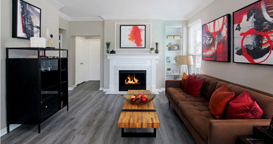 Luxury apartments with wood plank floors, gas fireplaces, built-in shelves, and gray wall color at Rockledge Oaks Apartments in Lincoln, Nebraska