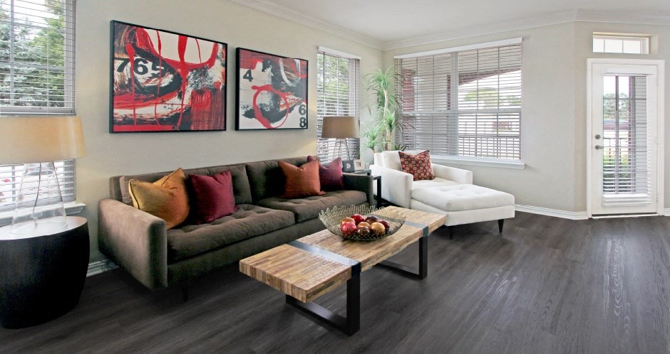 Luxury apartments with wood plank floors, spacious floor plan, oversized windows and gray wall color at Rockledge Oaks Apartments in Lincoln, Nebraska