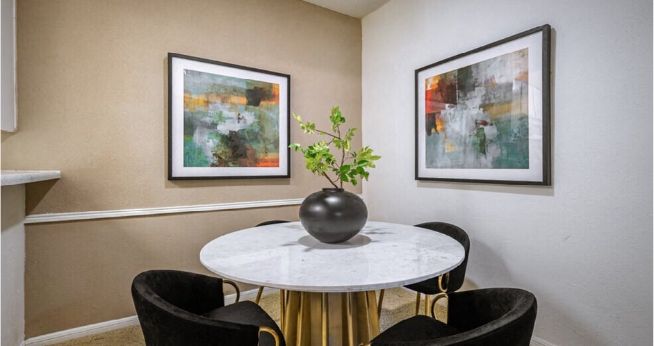 Dining room with taupe feature wall and breakfast bar at Woodlake Oaks Apartments in Houston