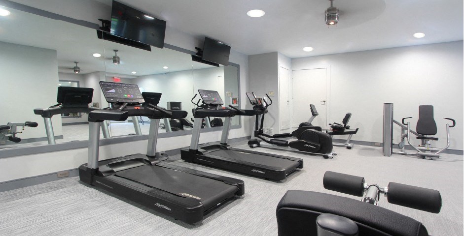 Newly remodeled Fitness Center open 24/7 with brand new Life Fitness equipment including 1 peloton bike, 4 resistance machines, 2 treadmills, 1 life cycle, 1 elliptical, full rack of free weights and dumbbells and water bottle refill fountain.