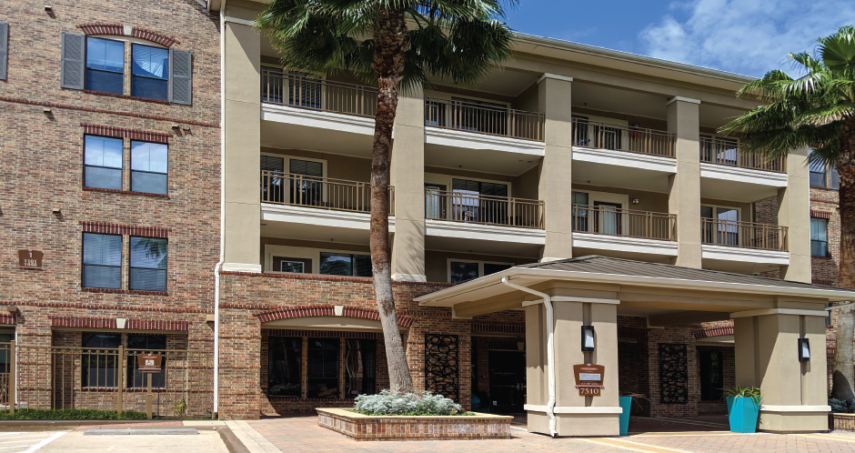 Luxury apartments with brick exteriors, two swimming pools, parking garage, and fitness center at The Voss Apartments in Houston.
