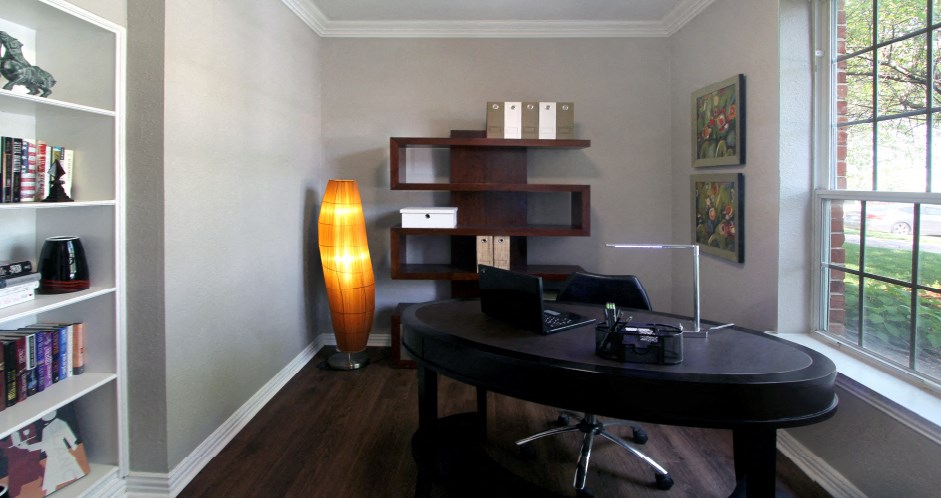 Luxury apartments with den, office space, wet bar, built-in shelves, oversized windows, and wood grain plank floors at Lenox Village Apartments in Lincoln, Nebraska