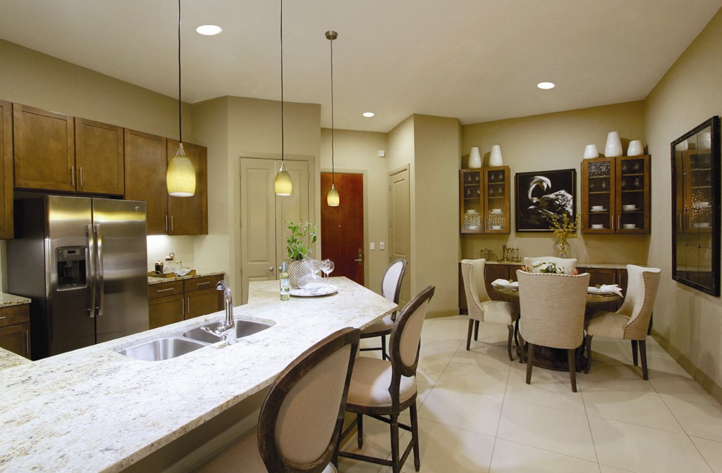 Spacious layout with built-in buffet with granite slab top in the dining room and 10-foot ceilings at Tuscany Walk Apartments in Houston Texas.