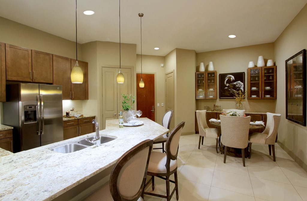 Spacious layout with built-in buffet with granite slab top in the dining room and 10-foot ceilings at Tuscany Walk Apartments in Houston Texas.