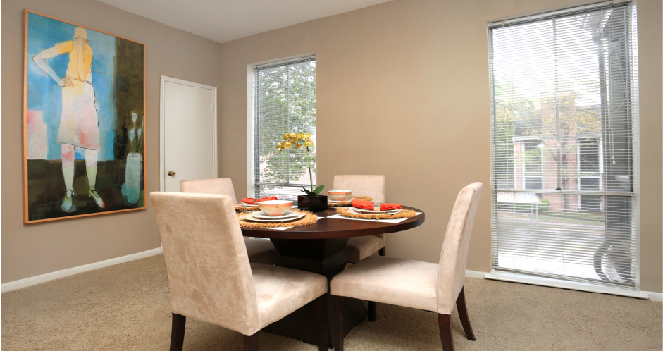 Spacious floor plan, spacious dining room with oversized windows and lots of natural light at Woodlake on the Bayou Apartments in Houston.