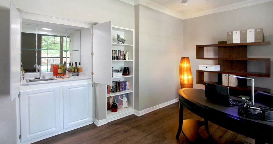 Luxury apartments with den, office space, wet bar, built-in shelves, and wood grain plank floors at Lenox Village Apartments in Lincoln, Nebraska