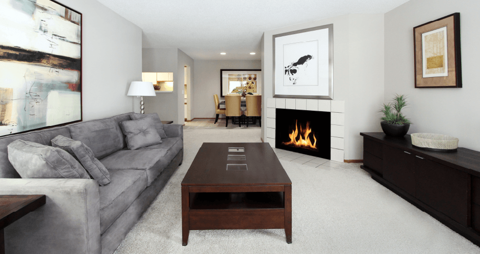Spacious floor plan, gray wall color, spacious apartment with woodburning fireplace, spacious kitchen, spacious dining room, and bright white kitchen at The Vanderbilt Apartments in central Omaha, Nebraska