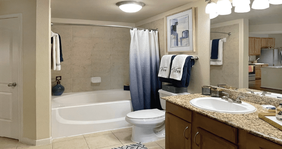 Spacious luxury bathrooms with granite slab vanity tops at The Voss Apartments in Houston.