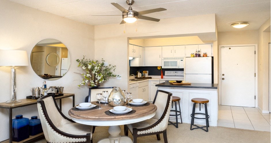 Apartments with open floor plan, spacious layout, colored feature wall, kitchen island, and prep island at Embassy Park Apartments in Omaha, Nebraska
