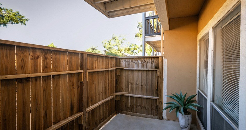 Private fenced in patio at Woodlake Oaks Apartments in Houston