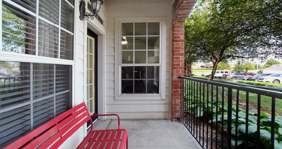 Luxury apartments with red brick exterior, spacious balconies, lush landscaping, and scenic views at Lenox Village Apartments in Lincoln, Nebraska