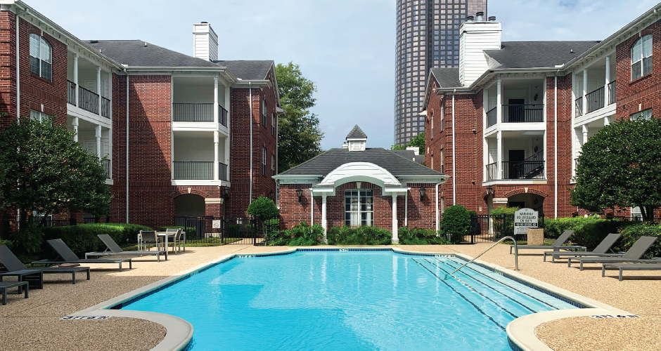 Luxury swimming pool with large sundeck at Tuscany Gate Apartments in Houston.